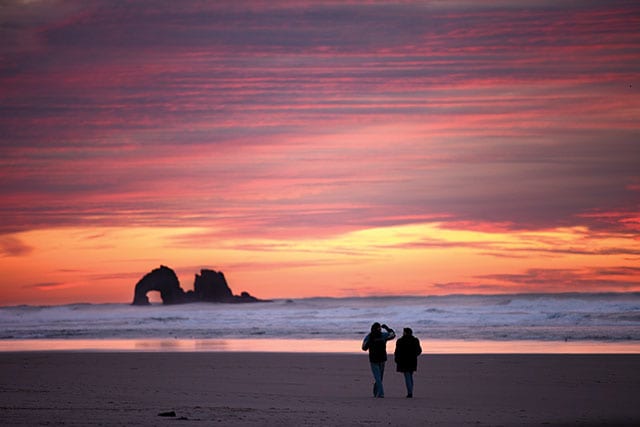 Couple strolling the beach, Rockaway Beach, Oregon