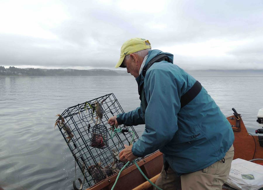 Man with a crab pot, Rockaway Beach, Oregon