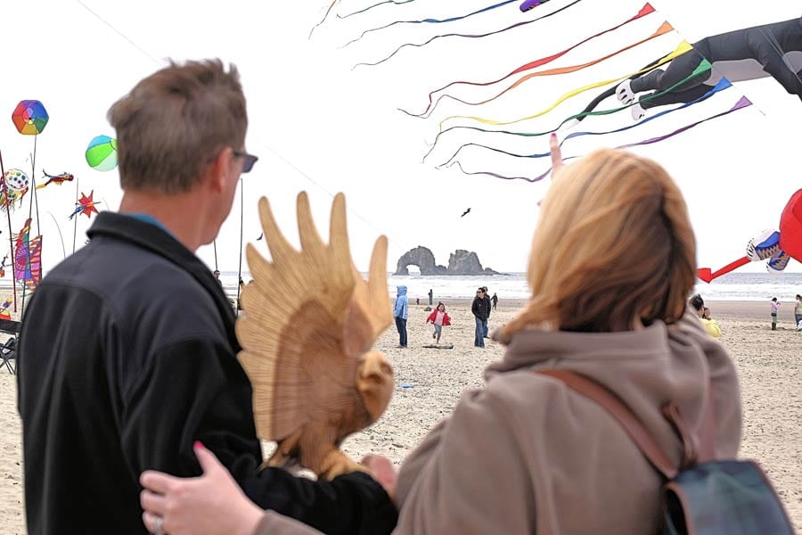 Couple flying kites, Rockaway Beach, Oregon