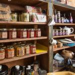 A shelf full of jam jars and snacks.