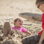 Children playing in the sand on Rockaway Beach.