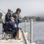 Fishing from a lakeside dock.